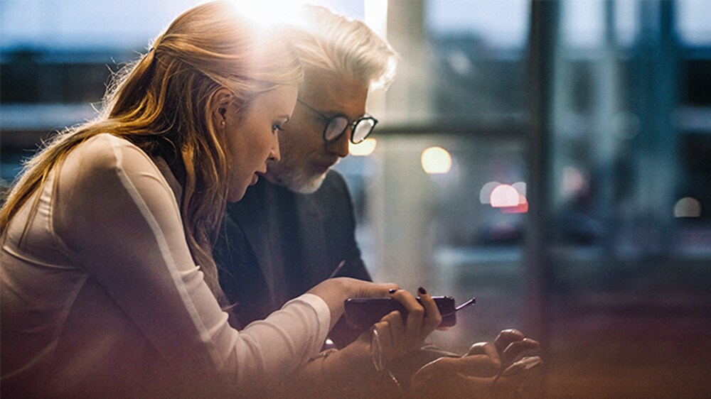 Two people are checking annual tax report