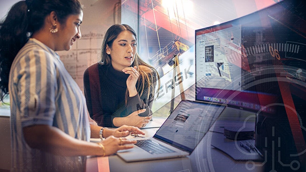 Maersk women employees looking at digital devices